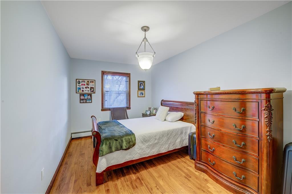 1262 East 73rd Street Brooklyn, NY 11234 - Photo 16 of 26 a bedroom with a bed and dresser