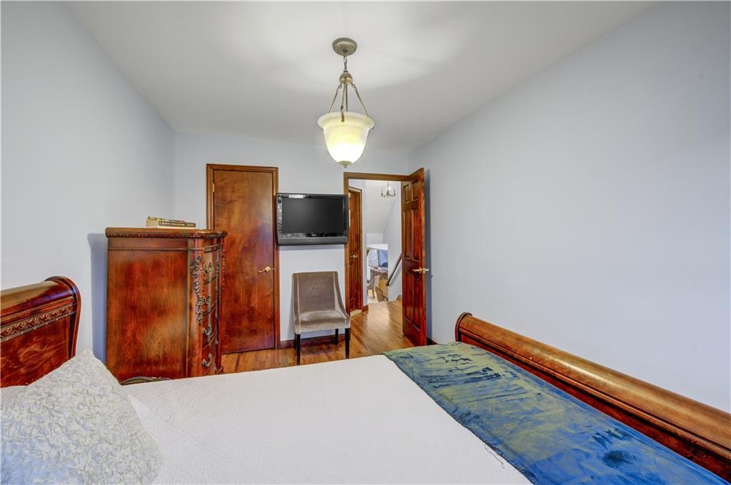 1262 East 73rd Street Brooklyn, NY 11234 - Photo 17 of 26 a bedroom with a bed and dresser