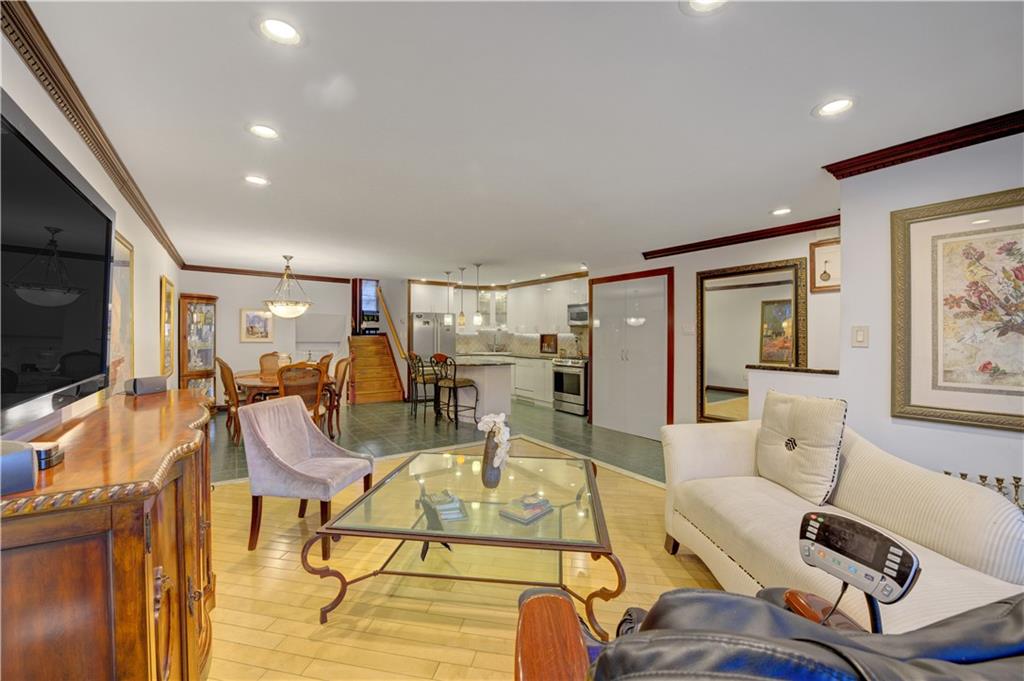 1262 East 73rd Street Brooklyn, NY 11234 - Photo 2 of 26 a view of a livingroom with furniture and a flat screen tv