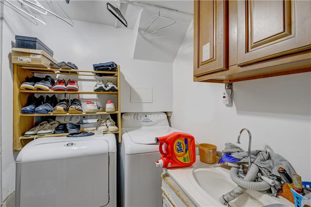 1262 East 73rd Street Brooklyn, NY 11234 - Photo 22 of 26 a storage room with washer and dryer