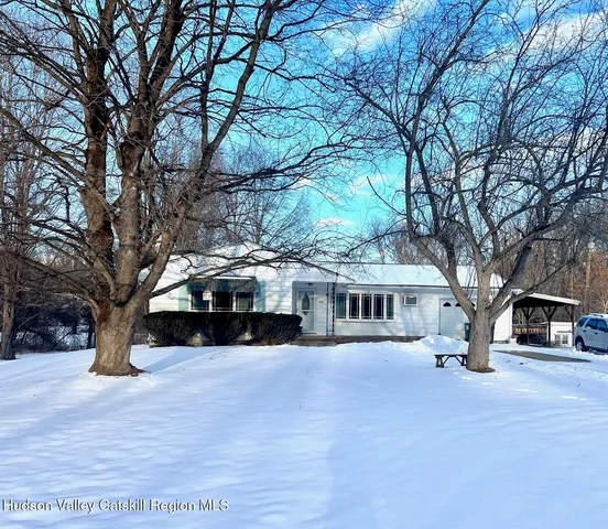 a view of house with a yard