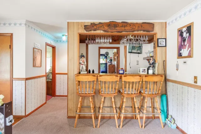 a view of a dining room with furniture a livingroom and chandelier