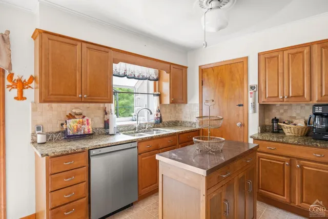 a kitchen with stainless steel appliances granite countertop a sink stove and cabinets