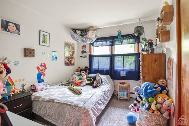 a bed room with two beds and a window