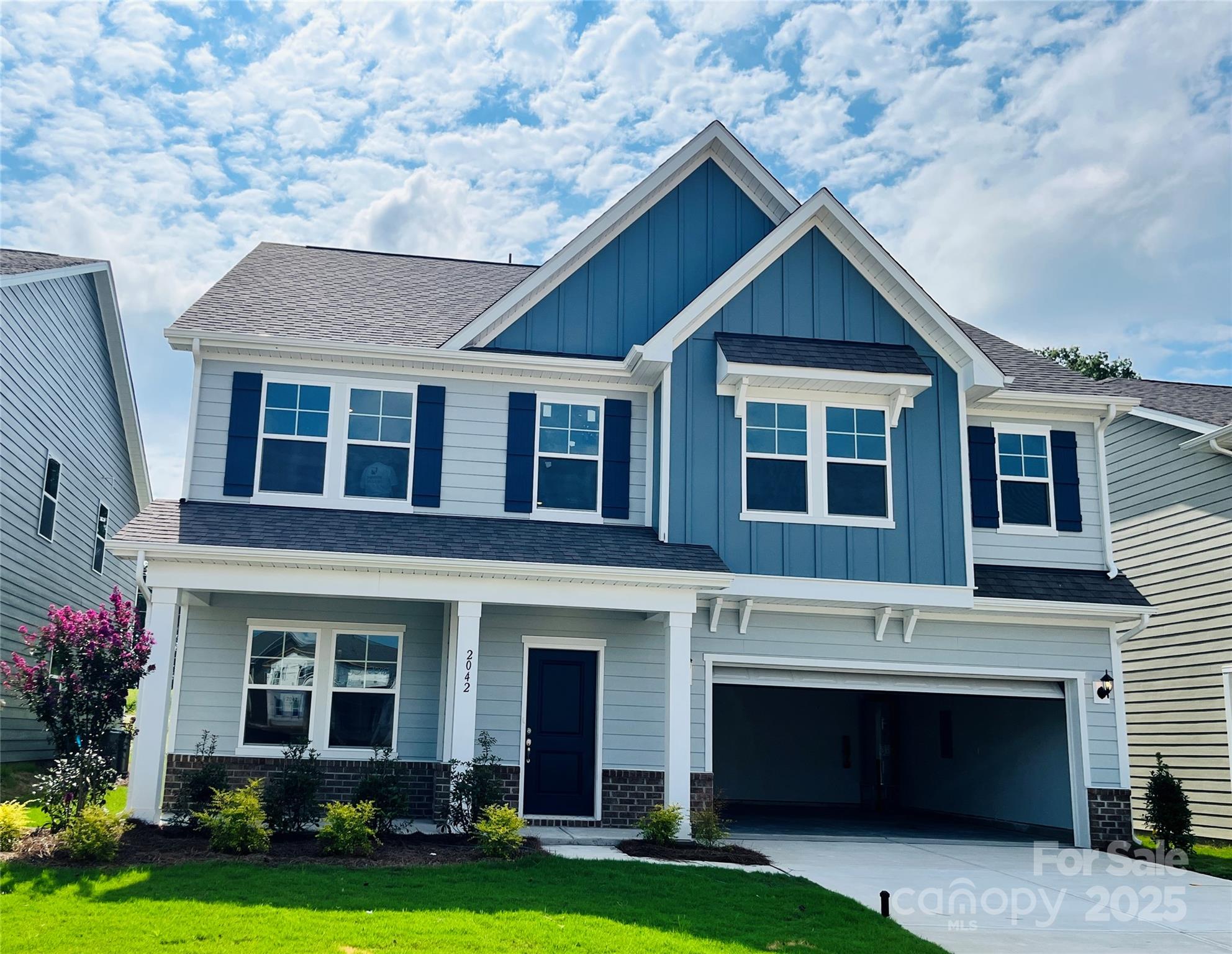 2042 Puddle Pond Road Indian Trail, NC 28079 - Photo 1 of 21 a front view of a house with a yard and garage