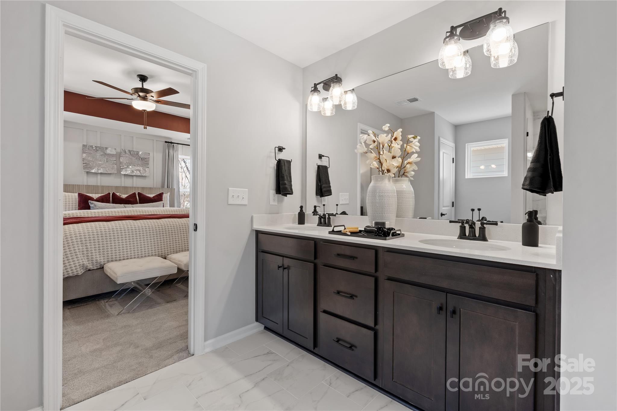 2042 Puddle Pond Road Indian Trail, NC 28079 - Photo 12 of 21 a en suite bathroom with double vanity sinks a vanity a lamp and a mirror