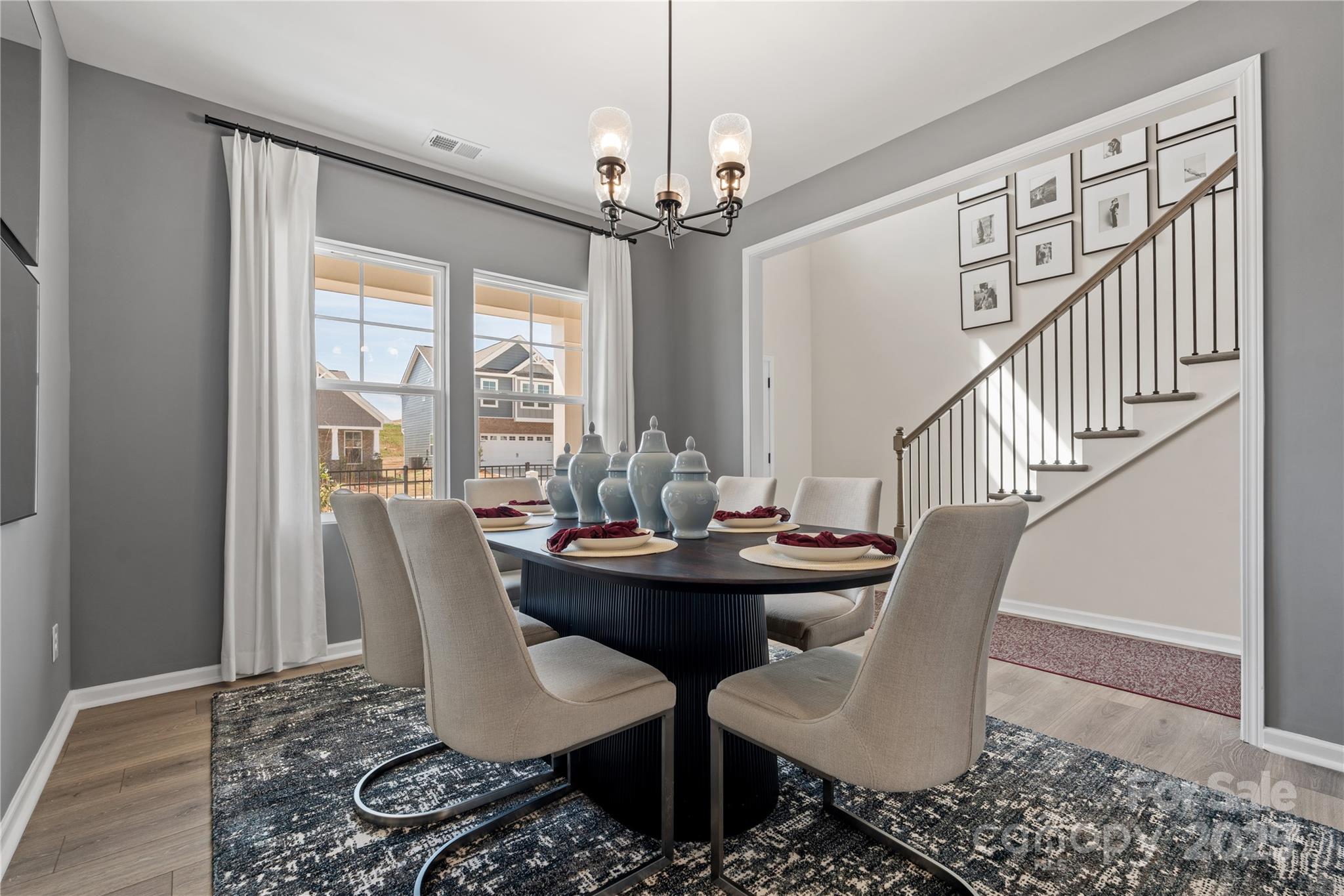 2042 Puddle Pond Road Indian Trail, NC 28079 - Photo 5 of 21 a dining room with furniture a chandelier and wooden floor