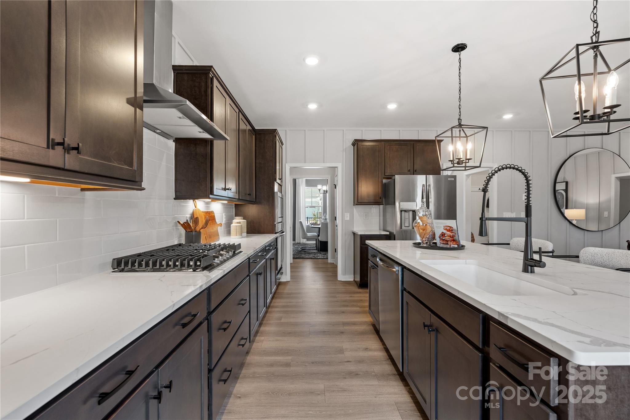 2042 Puddle Pond Road Indian Trail, NC 28079 - Photo 7 of 21 a kitchen with kitchen island granite countertop a stove a sink wooden floor cabinets and dining table