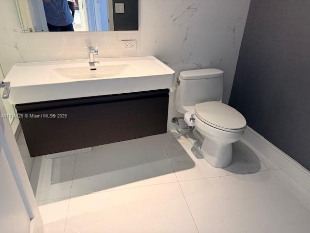 901 Brickell Key Boulevard, Unit 906 Miami, FL 33131 - Photo 18 of 60 a bathroom with a sink and a toilet