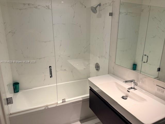 901 Brickell Key Boulevard, Unit 906 Miami, FL 33131 - Photo 19 of 60 a bathroom with a tub sink and mirror
