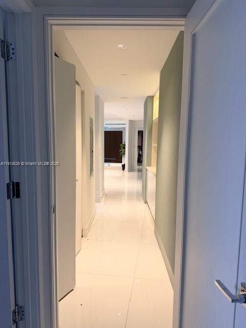 901 Brickell Key Boulevard, Unit 906 Miami, FL 33131 - Photo 23 of 60 a view of a hallway with wooden floor and a living room