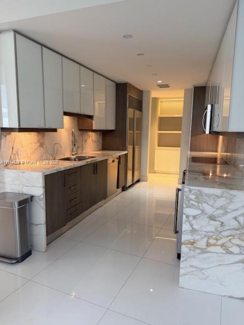 901 Brickell Key Boulevard, Unit 906 Miami, FL 33131 - Photo 25 of 60 a kitchen with stainless steel appliances granite countertop a stove a sink and a refrigerator