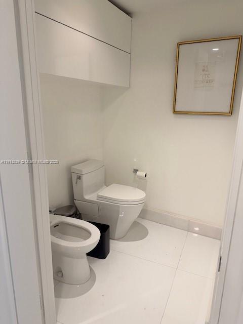 901 Brickell Key Boulevard, Unit 906 Miami, FL 33131 - Photo 27 of 60 a white toilet sitting next to a bathroom sink