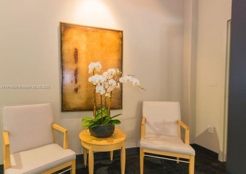 901 Brickell Key Boulevard, Unit 906 Miami, FL 33131 - Photo 57 of 60 a living room with furniture and a potted plant
