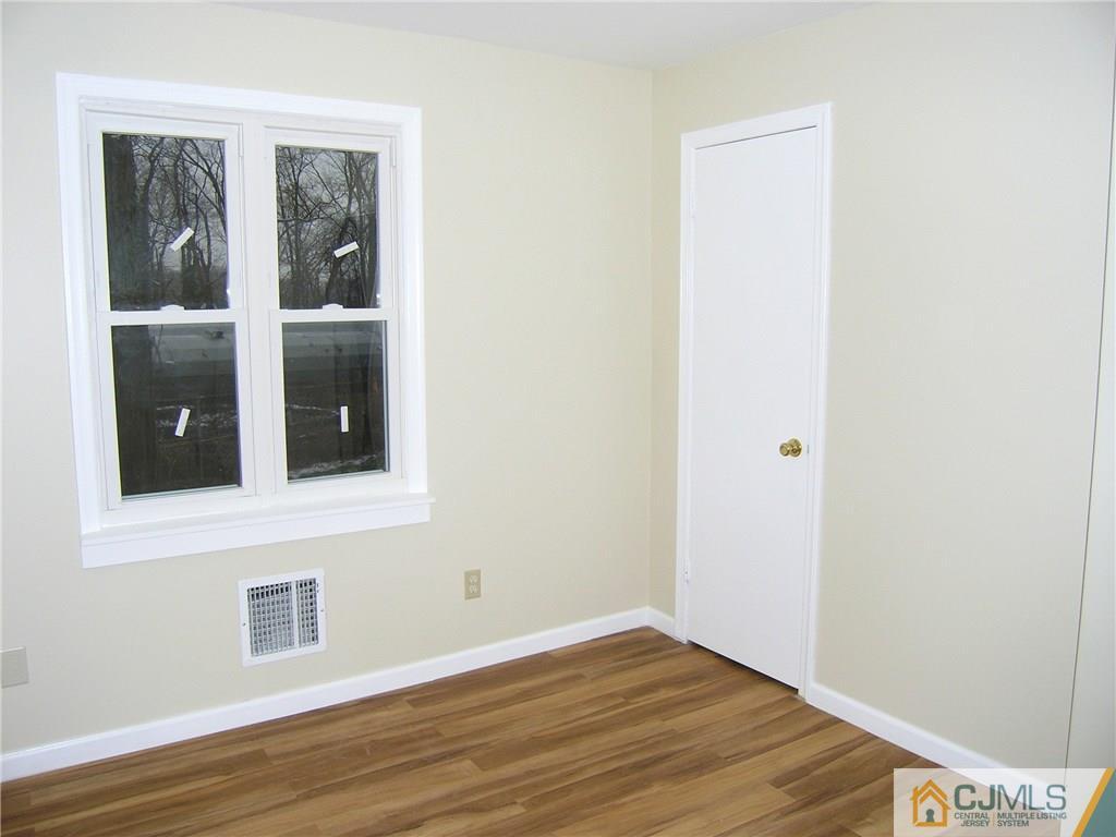 20 Pennington Road New Brunswick, NJ 08901 - Photo 5 of 15 a view of an empty room with wooden floor and a window