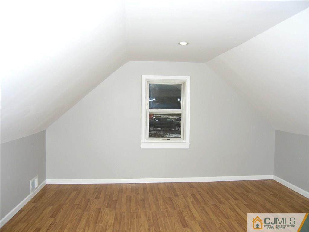 20 Pennington Road New Brunswick, NJ 08901 - Photo 8 of 15 a view of an empty room with wooden floor and a window