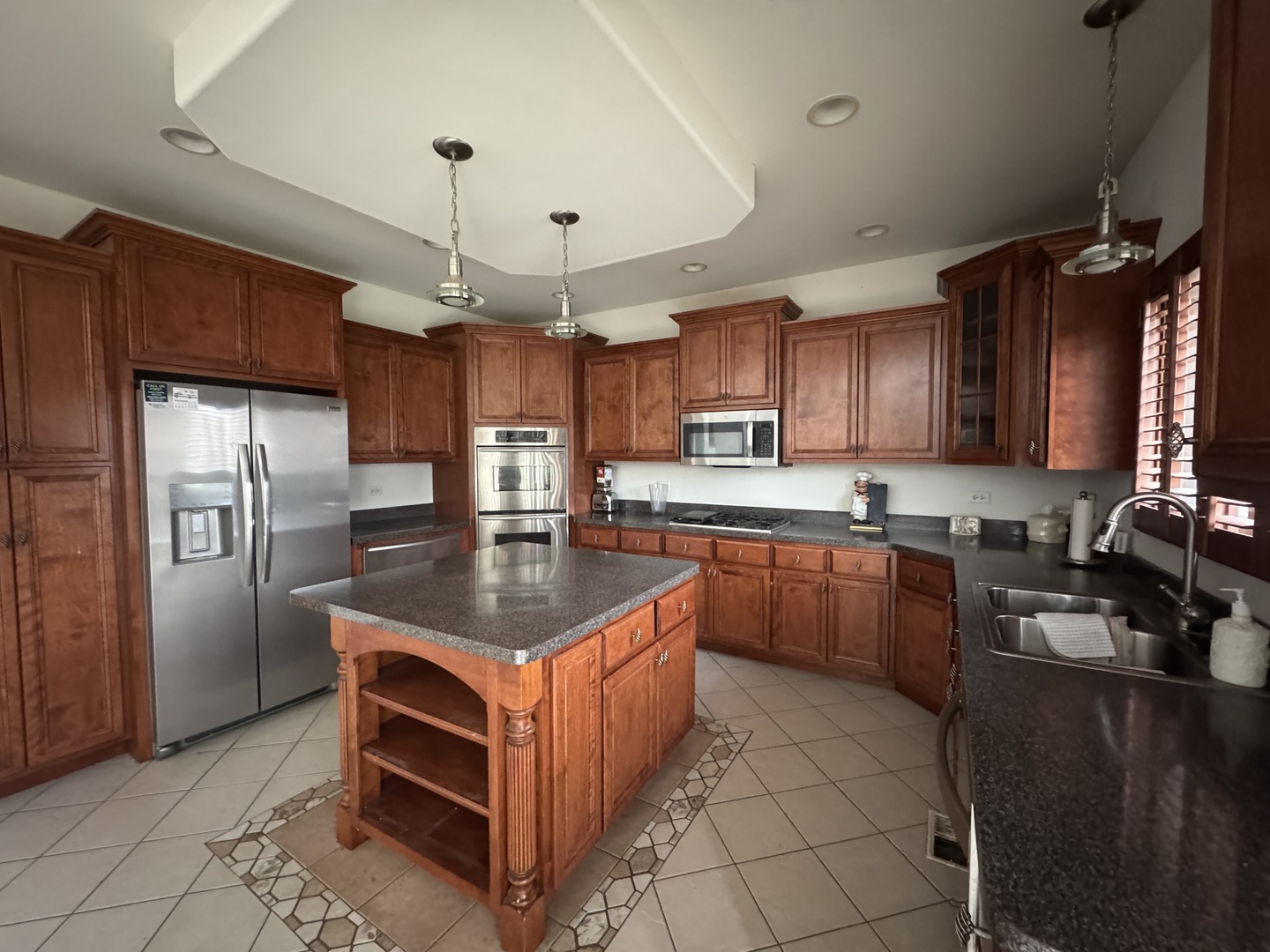 1008 Willow Road Matteson, IL 60443 - Photo 2 of 19 a kitchen with kitchen island granite countertop a sink counter top space appliances and cabinets