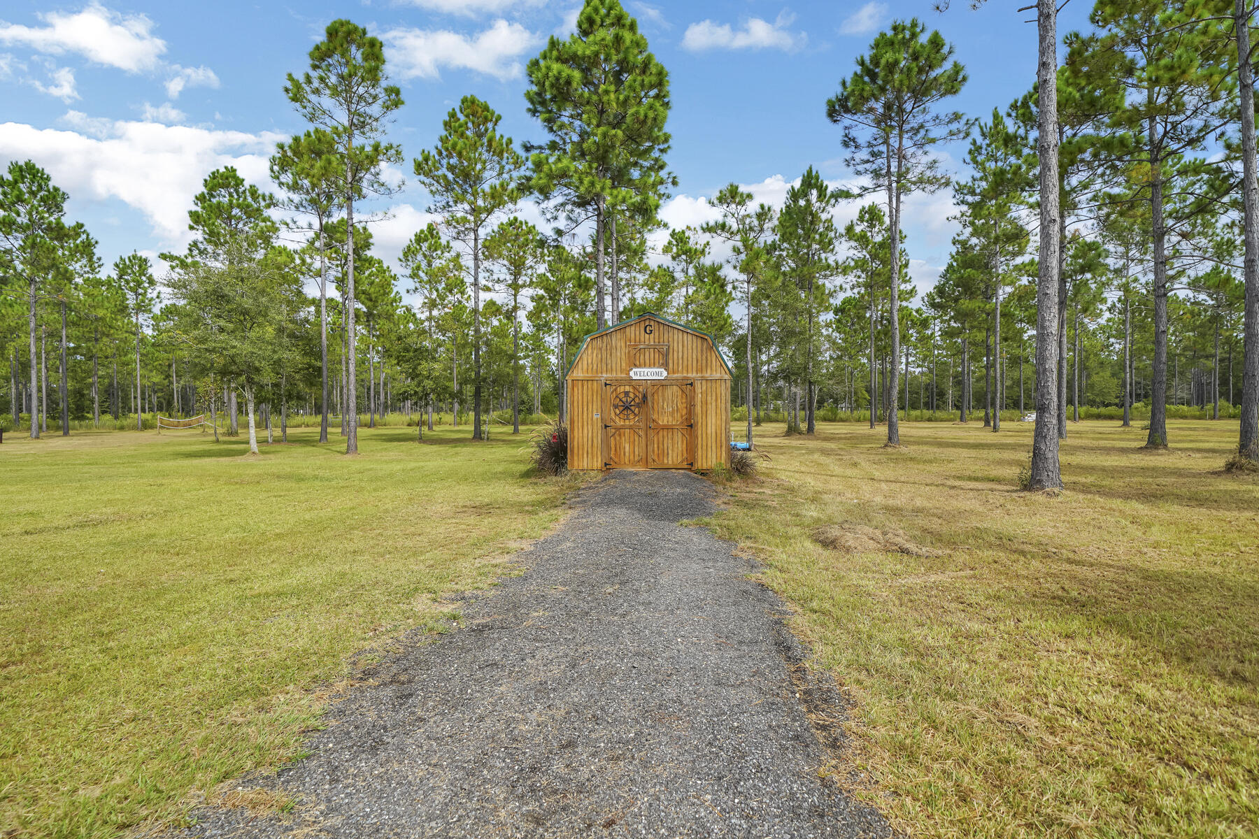 965 Melton Road Baker, FL 32531 - Photo 6 of 38 a swimming pool with trees in the background