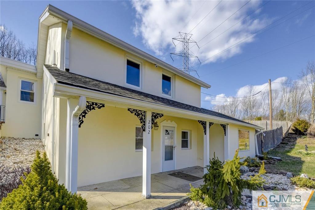 202 Higgins Road Old Bridge, NJ 07747 - Photo 2 of 25 a front view of a house with garden