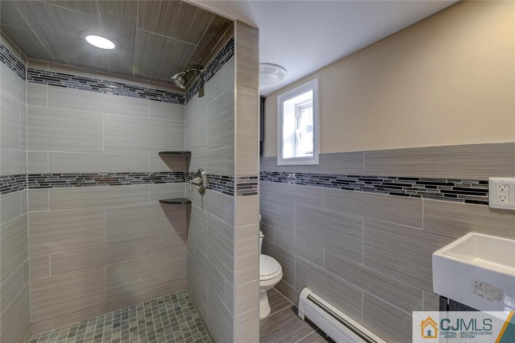 202 Higgins Road Old Bridge, NJ 07747 - Photo 13 of 25 a bathroom with a toilet and a shower