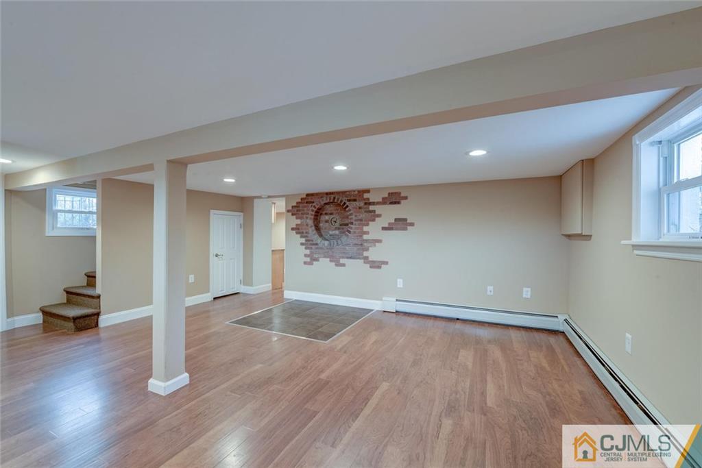 202 Higgins Road Old Bridge, NJ 07747 - Photo 16 of 25 wooden floor in an empty room with a window
