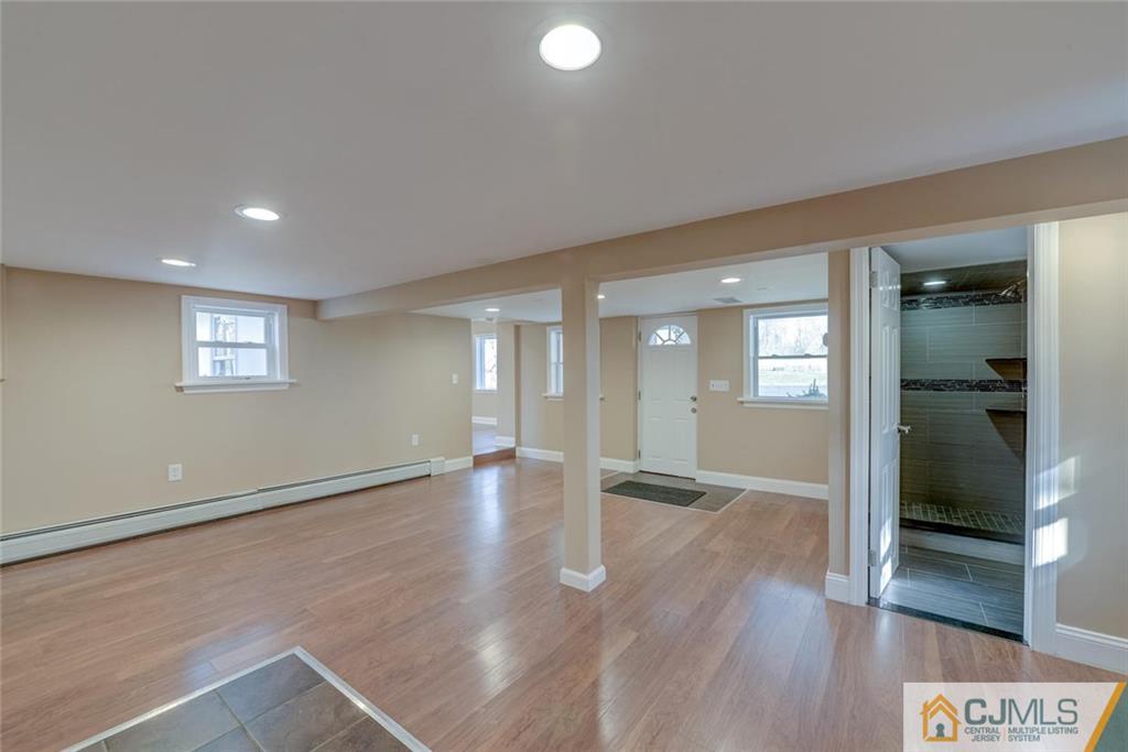 202 Higgins Road Old Bridge, NJ 07747 - Photo 17 of 25 wooden floor in an empty room with a window