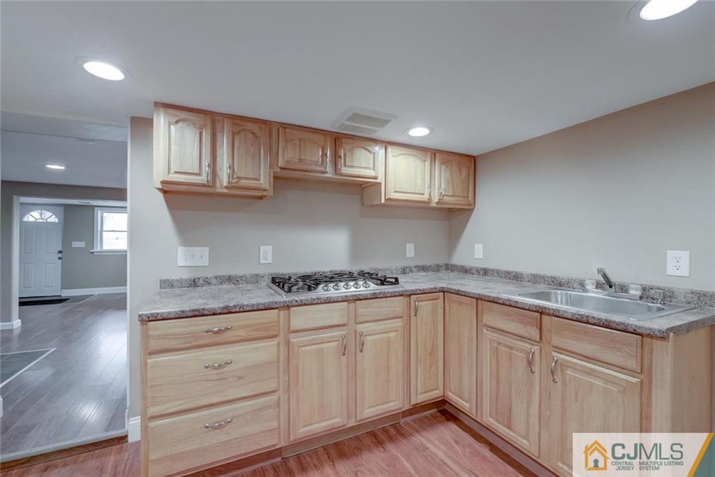 202 Higgins Road Old Bridge, NJ 07747 - Photo 18 of 25 a kitchen with granite countertop a sink and cabinets