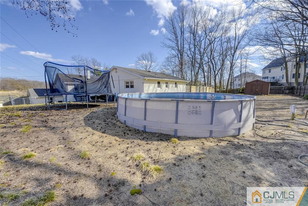 202 Higgins Road Old Bridge, NJ 07747 - Photo 22 of 25 a view of a large house with a yard covered with snow in the background