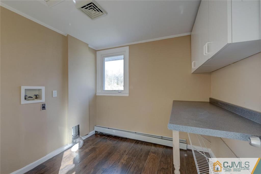 202 Higgins Road Old Bridge, NJ 07747 - Photo 9 of 25 a view of an empty room with wooden floor and a window