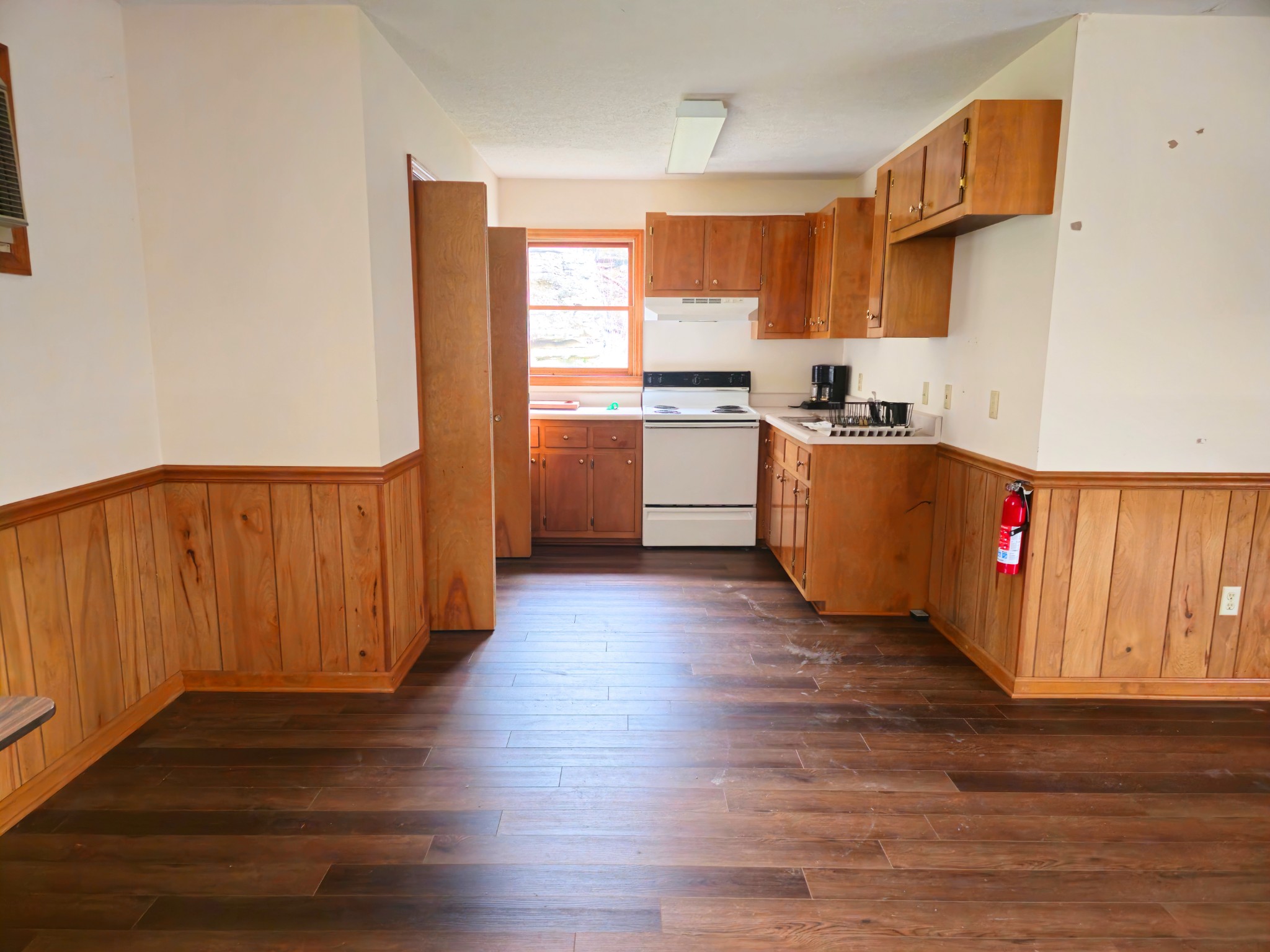 1124 Leach Road Cumberland Furnace, TN 37051 - Photo 15 of 18 a kitchen with wooden floors and white appliances