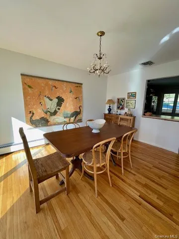 a view of a dining room with furniture wooden floor and chandelier