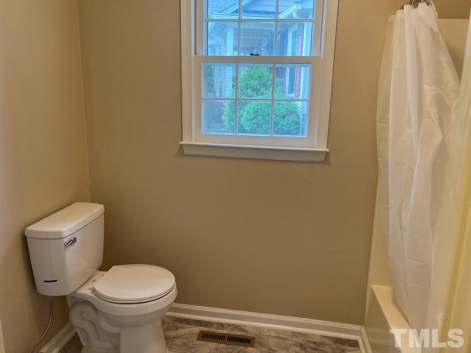 3632 Wickersham Way Raleigh, NC 27604 - Photo 8 of 32 a white toilet sitting next to a window