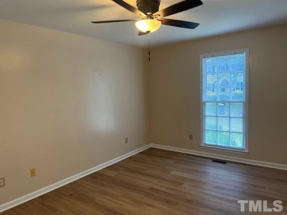 3632 Wickersham Way Raleigh, NC 27604 - Photo 10 of 32 an empty room with wooden floor and windows