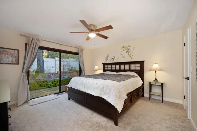 a spacious bedroom with a bed and window