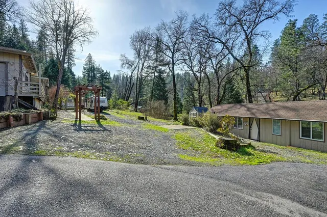a backyard of a house with barbeque oven and swing