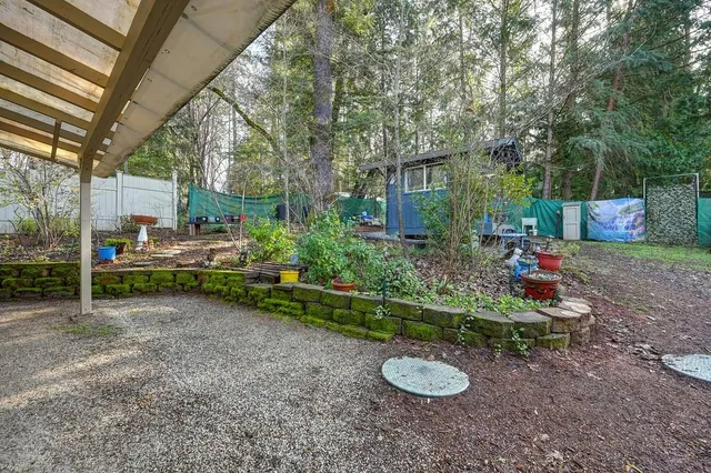 a view of a chair and table in backyard