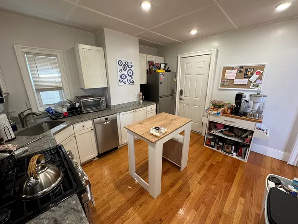 a kitchen with a sink appliances and cabinets