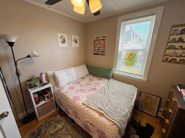 a bedroom with a bed and wooden floor