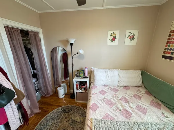 a bedroom with a bed and a rug