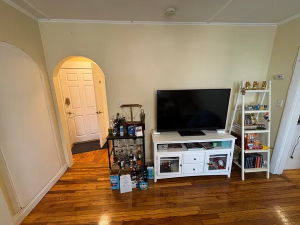 a living room with a flat screen tv and a fireplace