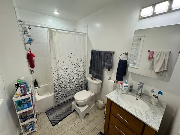a bathroom with a sink toilet and shower