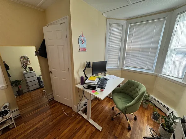 a view of a workspace with furniture and a window