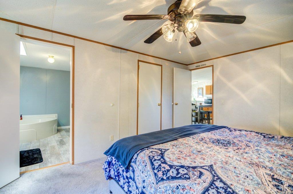 5029 Elon Road Monroe, VA 24574 - Photo 11 of 25 a bedroom with a bed and a chandelier