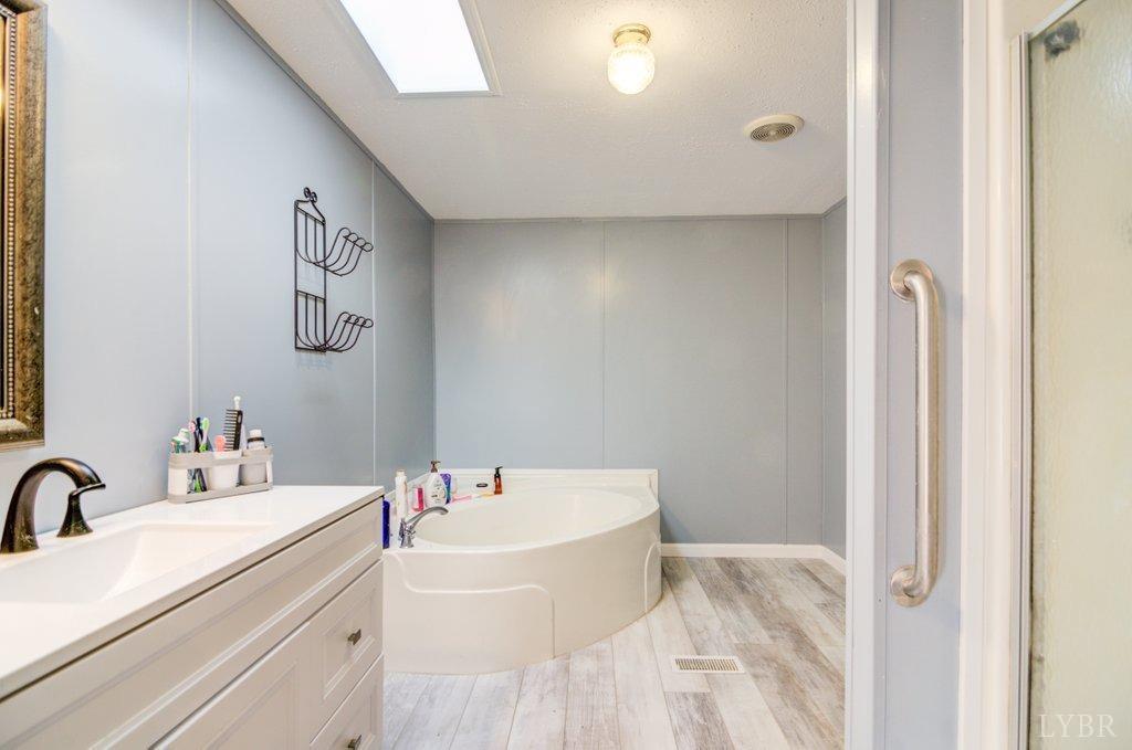 5029 Elon Road Monroe, VA 24574 - Photo 9 of 25 a bathroom with a bathtub and sink