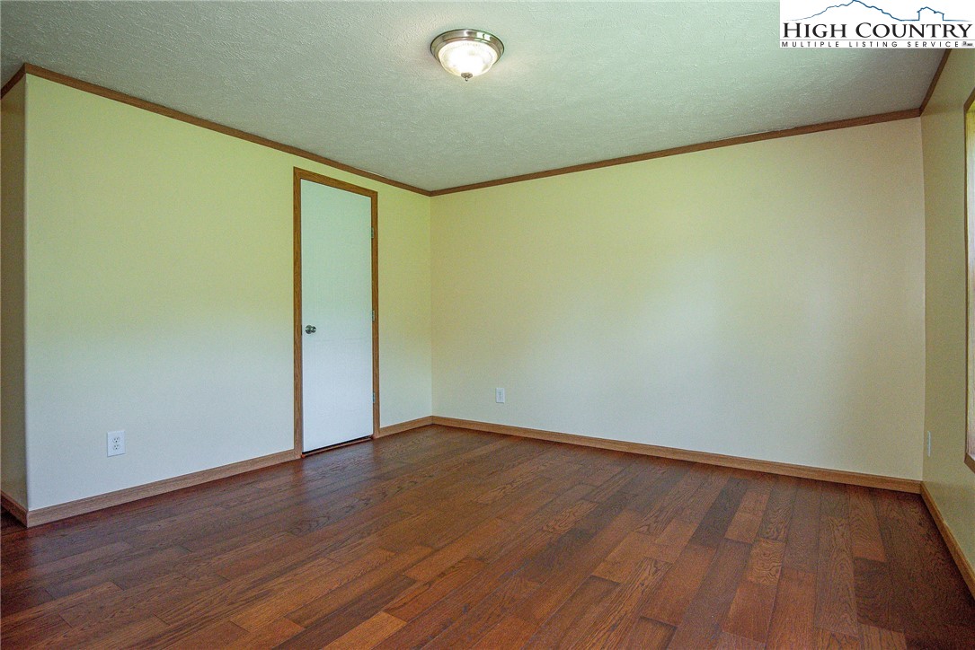 146 Fire House Road Whitetop, VA 24292 - Photo 18 of 44 a view of empty room with wooden floor