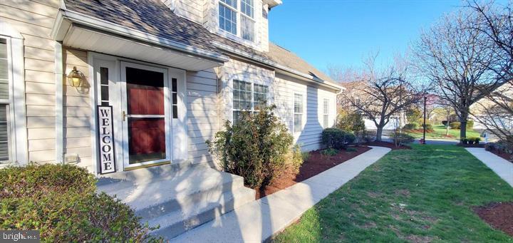 20153 Valhalla Square Ashburn, VA 20147 - Photo 22 of 26 a view of a house with brick walls and a yard with plants