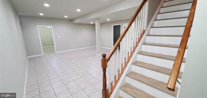 20153 Valhalla Square Ashburn, VA 20147 - Photo 4 of 26 a view of staircase with wooden floor and white walls