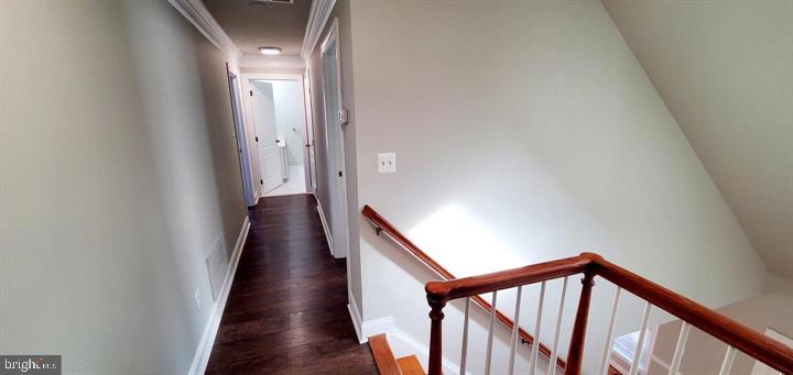 20153 Valhalla Square Ashburn, VA 20147 - Photo 7 of 26 a view of a hallway with wooden floor and stairs