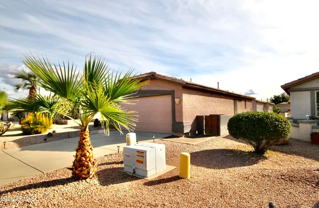 a view of a house with backyard and sitting area