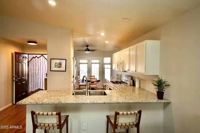a kitchen with granite countertop sink and cabinets